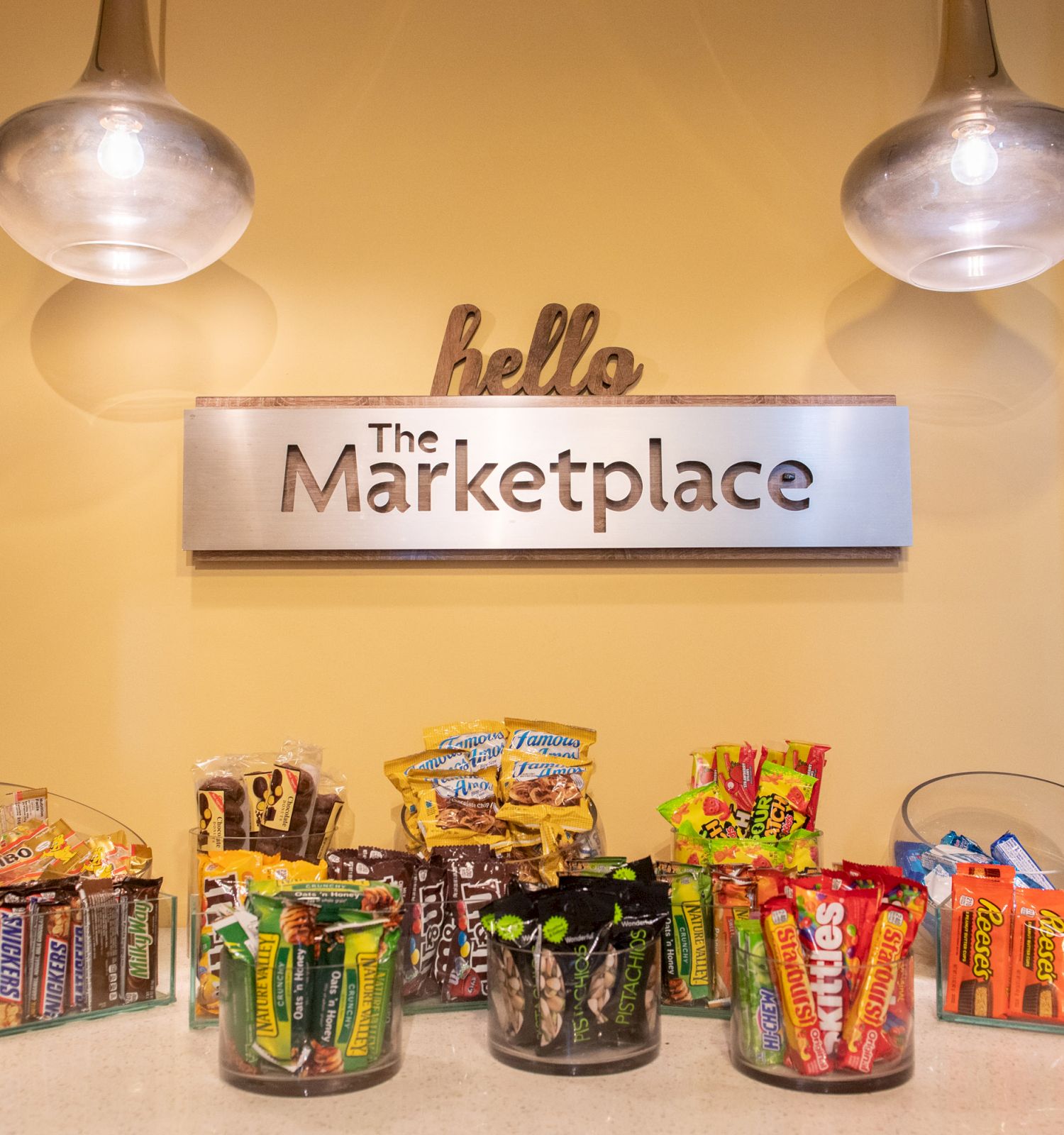 A display of various candy and snack items under a sign that reads 